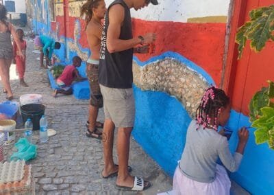 Arte d'Zona team in action, decorating a wall into a design of Cape Verdean flag
